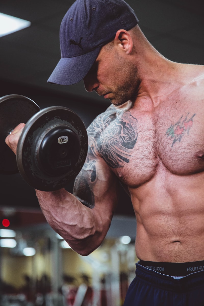 Bodybuilder bulking with heavy dumbbell